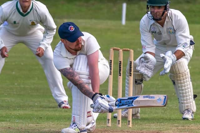 Ian Laing sweeps away a delivery