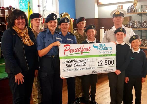 Proudfoot director Valerie Aston presents the cheque to the Sea Cadets.