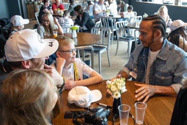 Lewis Hamilton chats to Jamie Winship and his family.