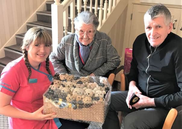 Magic Moments Club coordinator Skigh Beedham and residents Sheila Carlil and Dennis Muir with some of the knitted Bobby Buddies.