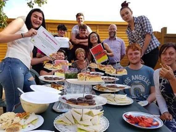 SASH young people, hosts, and staff during the tea party at the Rainbow Centre.