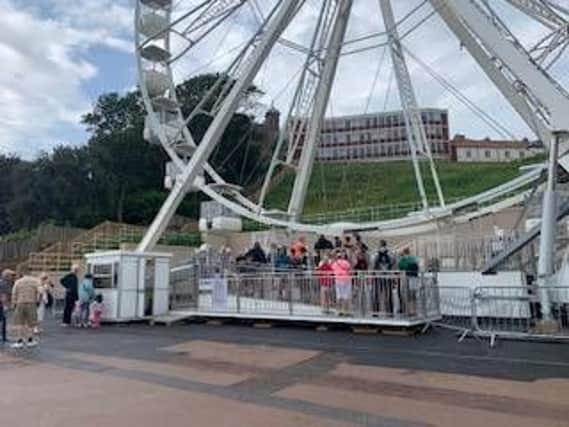 People line up to get on the wheel.