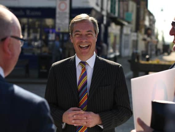Brexit Party leader Nigel Farage speaks to members of the public during a 'walkabout' campaigning for the European Parliament election in Pontefract in May.