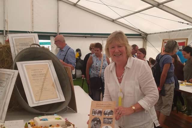 Show secretary Gena Douglas with the 100th show commemorative book