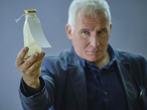 Simon Hedges with one of the bottles used in the installation at Scarborough Art Gallery