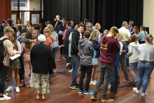 Students, staff and parents celebrate.