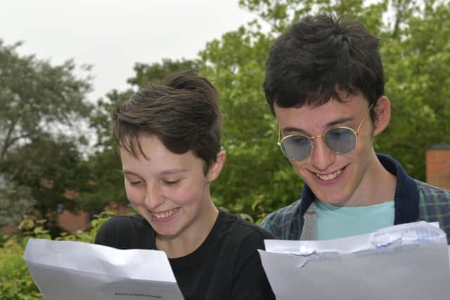 Amy Forrester and Simon Hoyle read their results. PIC: Richard Ponter
