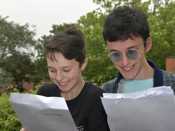 Amy Forrester and Simon Hoyle read their results. PIC: Richard Ponter