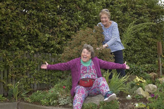 Pat Brighton and Hilda Osburn celebrate finishing their rockery.