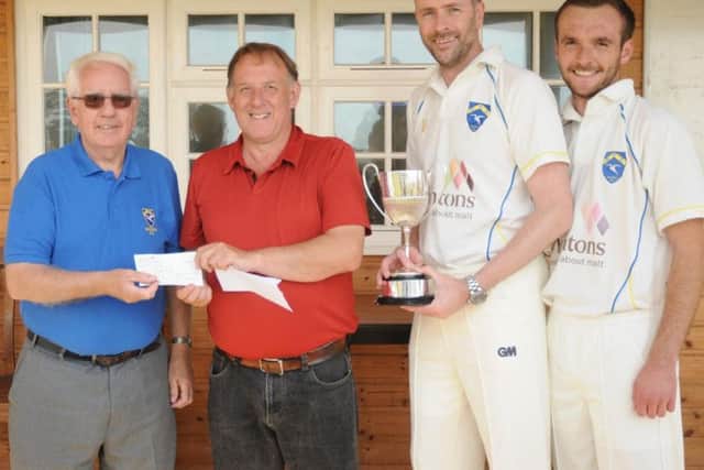 Sewerby President Ken Saul receives a league winners cheque from acting league secretary Malcolm Maw with Sewerby Captain Ian Dennis and Vice Captain Alex Shipley