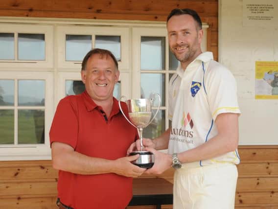 TROPHY TIME: Malcolm Maw, the acting Beckett League secretary, presents Sewerby captain Ian Dennis with the Division Two league winners trophy