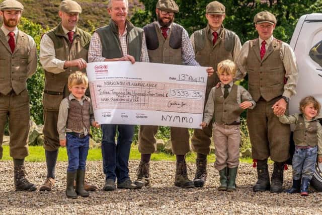 Jimmy Shuttlewood (far right) with a group of keepers and next generation gamekeepers, Jimmys young sons Arthur, Oscar and Rupert, handing over a cheque to the Yorkshire Air Ambulance for 3,333.33.