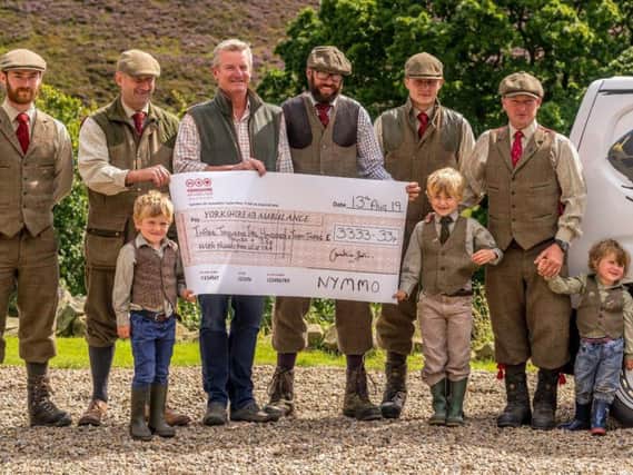 Jimmy Shuttlewood (far right) with a group of keepers and next generation gamekeepers, Jimmys young sons Arthur, Oscar and Rupert, handing over a cheque to the Yorkshire Air Ambulance for 3,333.33.