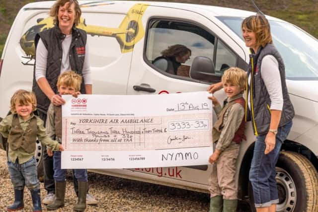 Tessa Klemz (left) and Linda Stead (right) of the Yorkshire Air Ambulance receiving a cheque for 3,333.33 from next generation gamekeepers, Jimmy Shuttlewoods young sons Arthur, Oscar and Rupert.