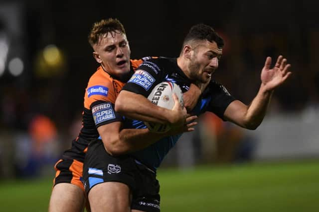 Tigers' Jake Trueman tackles Hull's Jake Connor.