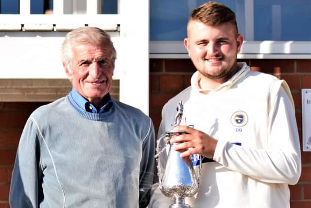 Hospital Cup president Mick Blackborrow hands the trophy to Filey skipper David Brannan