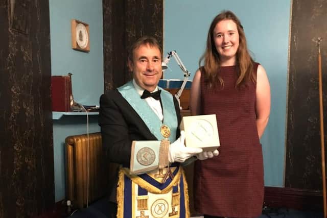John Colling with the stone block presented by Emma Waitzmann