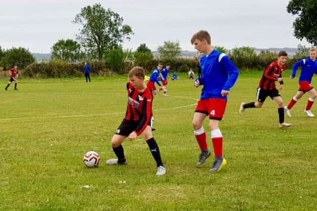 Phoenix Colts Under-15s, red and black stripes, in action during the win against Copmanthorpe