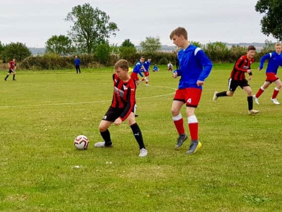Phoenix Colts Under-15s, red and black stripes, in action during the win against Copmanthorpe