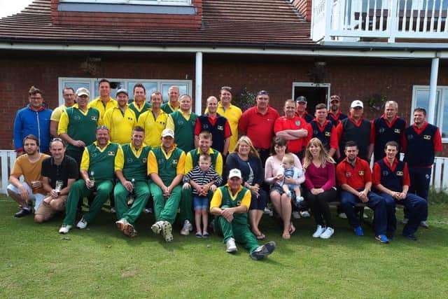 Friends and family of Gary Jones line up with the two teams before the memorial match at Flixton CC