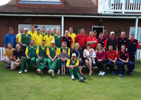 Friends and family of Gary Jones line up with the two teams before the memorial match at Flixton CC
