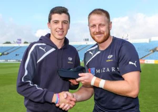 Picture by Alex Whitehead/SWpix.com - 28/08/2014 - Cricket - Royal London One-Day Cup Quarter Final - Yorkshire CCC v Durham CCC - Headingley Cricket Ground, Leeds, England - Yorkshire's Matthew Fisher receives his second team cap from captain Andrew Gale.