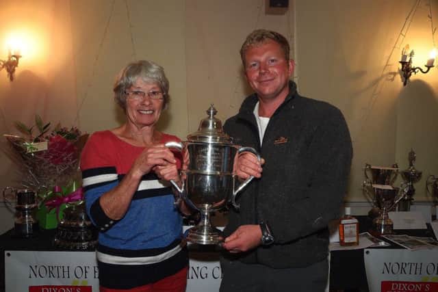 Scarborough angler Matty Hillaby receives the North of England Codling championship trophyand £500 from match sponsor Mrs Dixon of Dixons Discount Warehouse