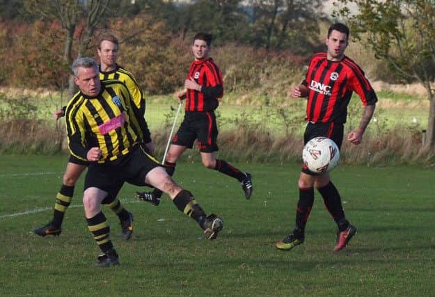 Scalby's Jake Scutt clears during their 6-0 defeat at West Pier. Picture: Steve Lilly