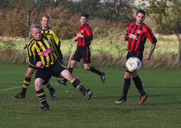 Scalby's Jake Scutt clears during their 6-0 defeat at West Pier. Picture: Steve Lilly