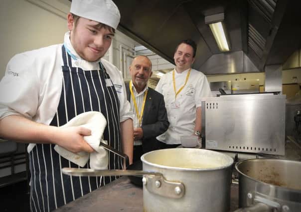 Yorkshire Coast College cooking competition with  Jamie Webster working  hard ,with President of Rotary Scarborough Cavaliers Mike Wilkinson,and James Mackenzie.. pic Richard Ponter 144826a