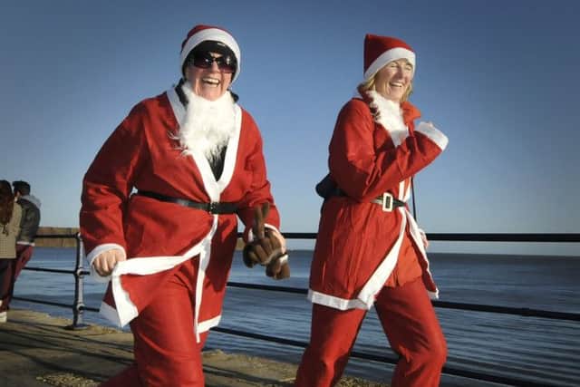 The St Catherines Hospice Santa Dash at Filey Country Park.Smiles to the finish line..Picture Richard Ponter 124957h