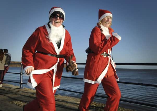 The St Catherines Hospice Santa Dash at Filey Country Park.Smiles to the finish line..Picture Richard Ponter 124957h