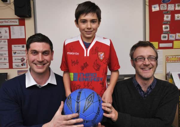 144831 West Heslerton School are presented with a signed Scarborough Atletic shirt to auction for the school From left Shaun Zablocki of sponsor Third Energy,Benjamin North and Nick Finch,commercial director at Scarborough Athletic. Picture by Neil Silk 28/11/14