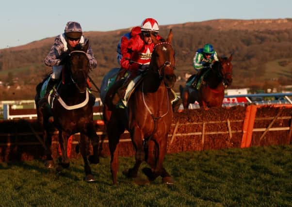 The New One ridden by Sam Twiston-davies (right) jumps the last with Vaniteux ridden by Barry Geraghty (left) on their way to victory in the StanJames.com International Hurdle during day two of The International at Cheltenham Racecourse, Cheltenham. PRESS ASSOCIATION Photo. Picture date: Saturday December 13, 2014. See PA story RACING Cheltenham. Photo credit should read: David Davies/PA Wire