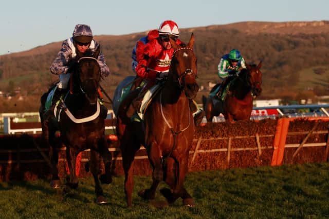 The New One ridden by Sam Twiston-davies (right) jumps the last with Vaniteux ridden by Barry Geraghty (left) on their way to victory in the StanJames.com International Hurdle during day two of The International at Cheltenham Racecourse, Cheltenham. PRESS ASSOCIATION Photo. Picture date: Saturday December 13, 2014. See PA story RACING Cheltenham. Photo credit should read: David Davies/PA Wire