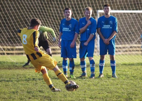 A Westover man aims a free kick over the Filey wall. Pictures: Steve Lilly