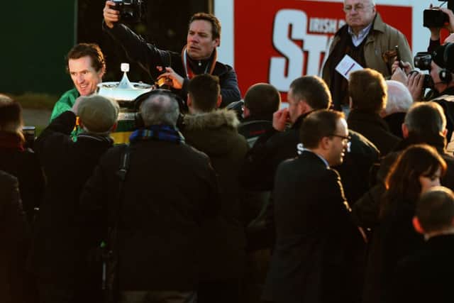 Jockey Tony McCoy with the Gold Cup after guiding Carlingford Lough to victory in the Hennessy Gold Cup during the Hennessy Gold Cup Day at Leopardstown Racecourse, Ireland. PRESS ASSOCIATION Photo. Picture date: Sunday February 8, 2015. See PA story RACING Leopardstown. Photo credit should read: Brian Lawless/PA Wire