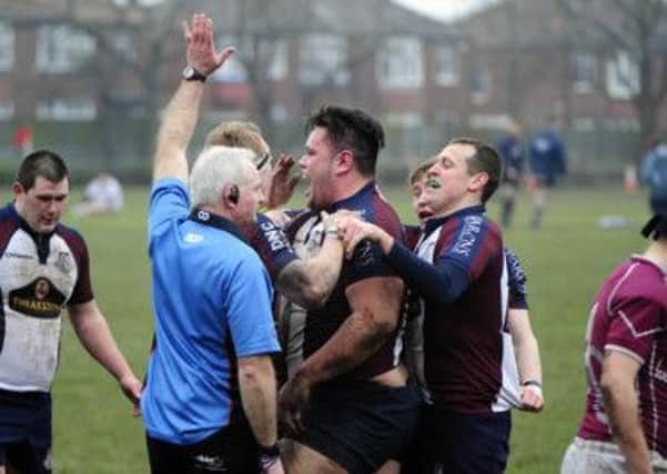 Two-try cup hero Wesley Langkilde is congratulated by his Scarborough RUFC teammates