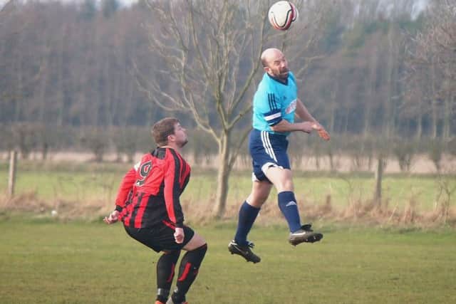 Newlands skipper Nick Beal rises high to clear the danger.