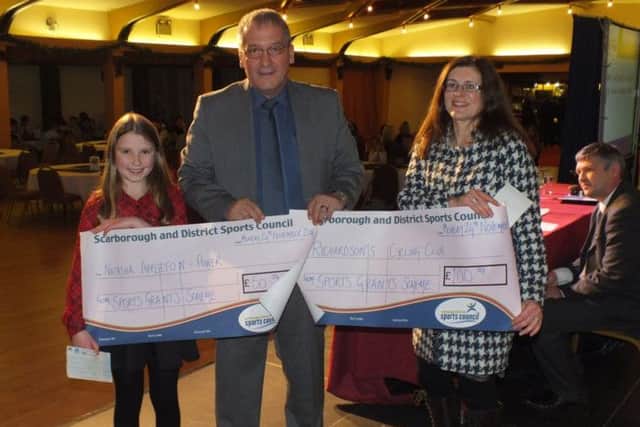 Grant recipients Natasha Appleton-Power and Debbie Mutton of Richardsons Cycling Club receive their cheques from Scarborough and District Sports Council chairman Chris Rhodes