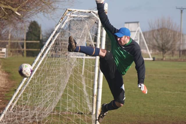 Seamers Joe Wright acrobaticly concedes a corner