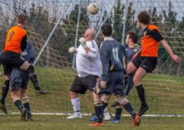 Whitby keeper Paul Cull can't keep this effort from Edgehill's Phil Warnett out. Pictures: Steve Lilly