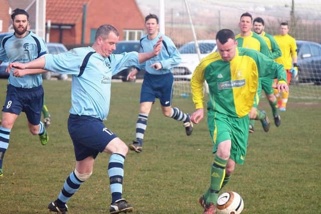Cayton player-boss Shaun Rennison holds up Duchess goalscorer Ian Laing