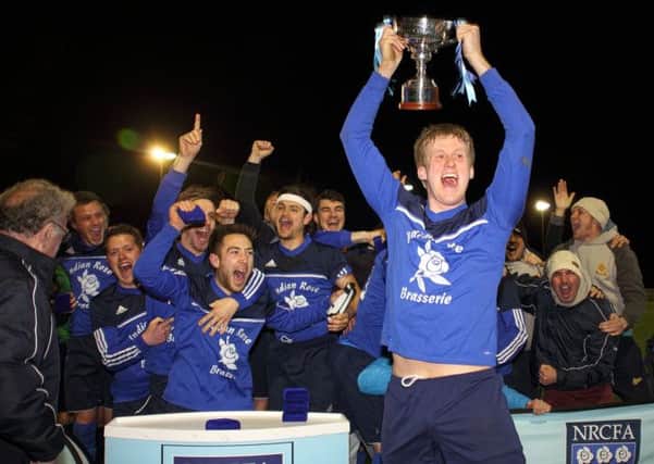Ben Salt, who is missing for Traf, holds up the North Riding FA Sunday Challenge Cup in 2013
