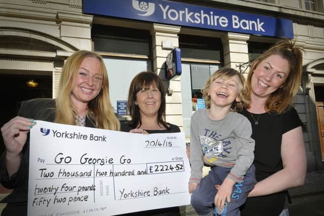Go Georgie charity continues.Yorkshire Bank raise cash.Branch Manager Leeds Emma Jo Beadle,Scarborough Branch Supervisor Kelly Mcsweeney. Georgie and Mum Naomi Jamieson.pic Richard Ponter 151605c