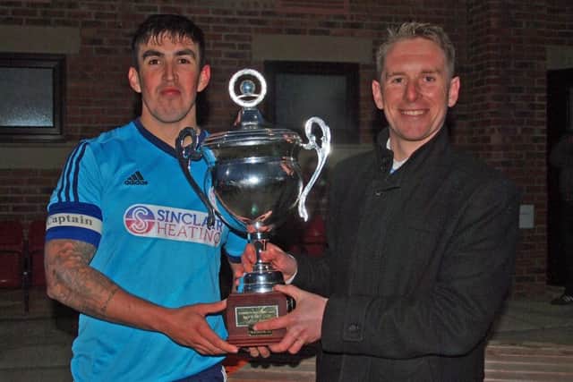 Newlands captain Matty Griffithsreceives the Kenward Cup from Sunday League's Geoff Osguthorpe