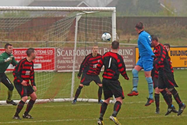 Shaun Dodson rises high and heads at goal. 151901g Steve Lilly