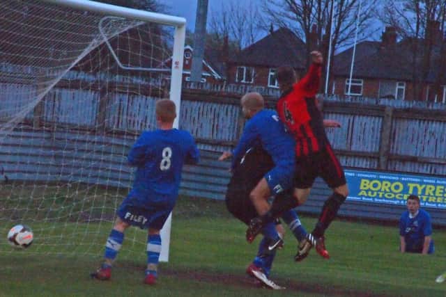 Gaz Thomas breaks the Filey hearts with a late header to earn West Pier District Cup success. 151907d Steve Lilly