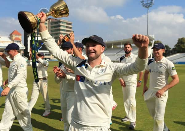 File photo dated 12-09-2014 of Yorkshire's Adam Lyth celebrates winning the Division One County Championship trophy during day four of the LV= County Championship Division One match at Trent Bridge, Nottingham.PRESS ASSOCIATION Photo. Issue date: Tuesday December 16, 2014. At 27, Lyth is hardly a newcomer but a stellar 2014 season for Yorkshire has put him in pole position to partner England captain Alastair Cook in next summer's Ashes series. Doubts over Sam Robson, the most recent man to hold the post, are all too evident and Lyth's main competition may well come from his Yorkshire opening partner Alex Lees, who at 21 looks the long-term solution. All three will have the chance to stake their claim on the England Lions tour to South Africa in January. See PA story SPORT Christmas 10 to watch. Photo credit should read Mike Egerton/PA Wire.