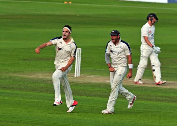 TAKE THAT: Yorkshire's Jack Brooks celebrates with Tim Bresnan after taking the wicket of Durham Michael Richardson. Picture: Tony Johnson